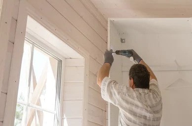 Man installing a DIY closet system